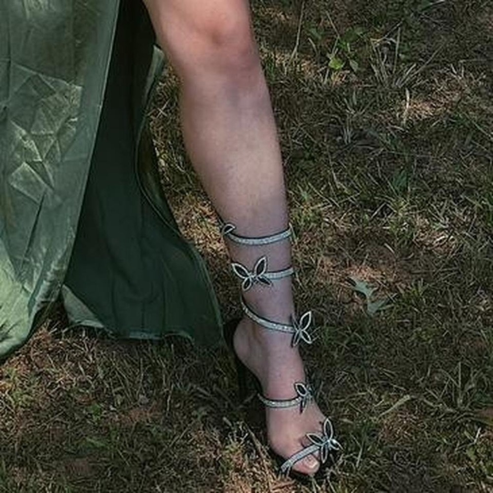Elegant black strappy heels with rhinestone butterfly details